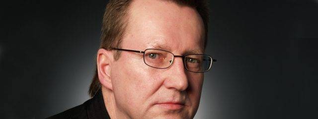 Optometrist, middle aged man wearing prescription eyeglasses in Toronto, ON